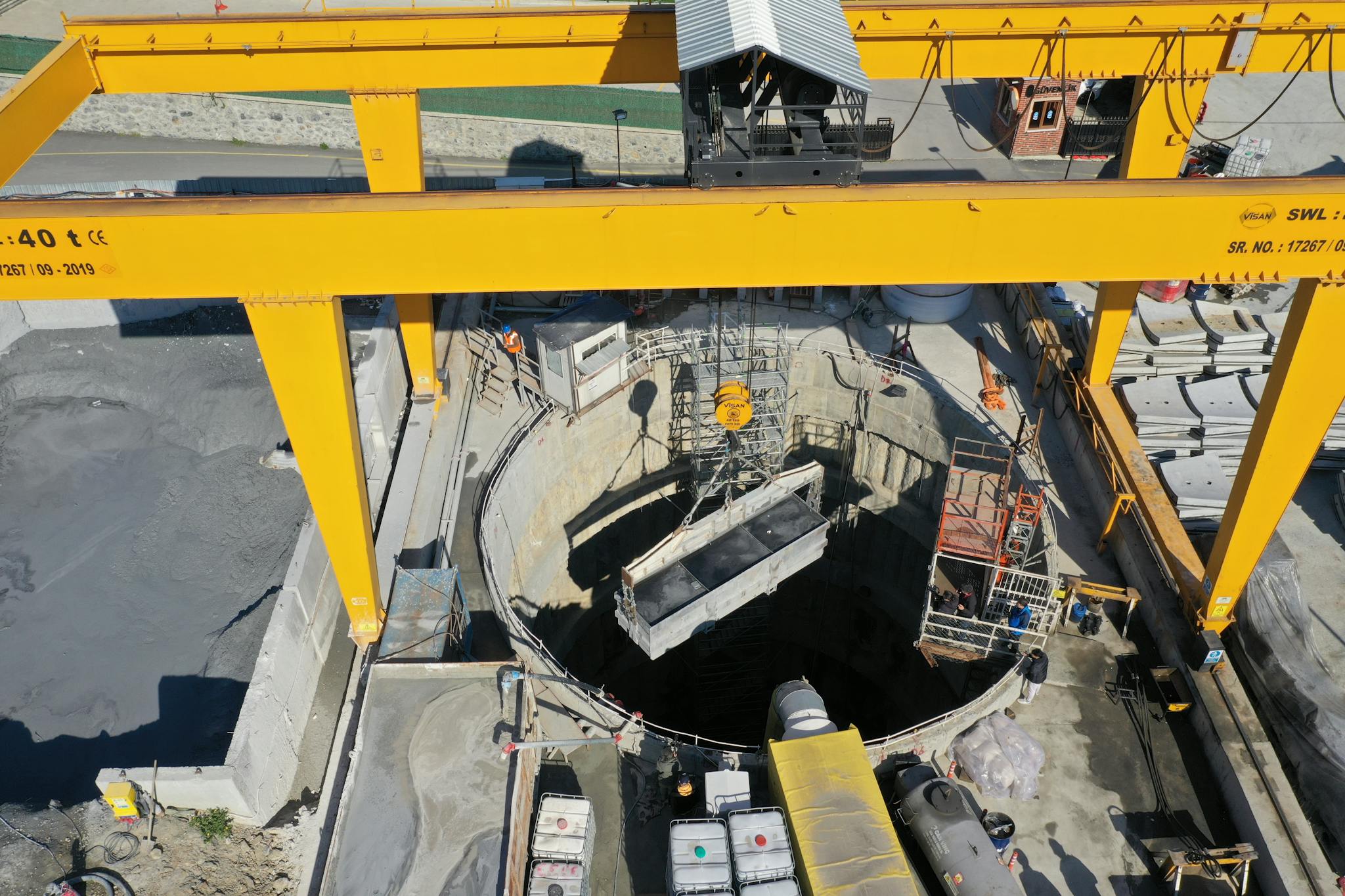High-angle aerial view of a construction site in Eyüpsultan, Istanbul, featuring industrial equipment and workers.